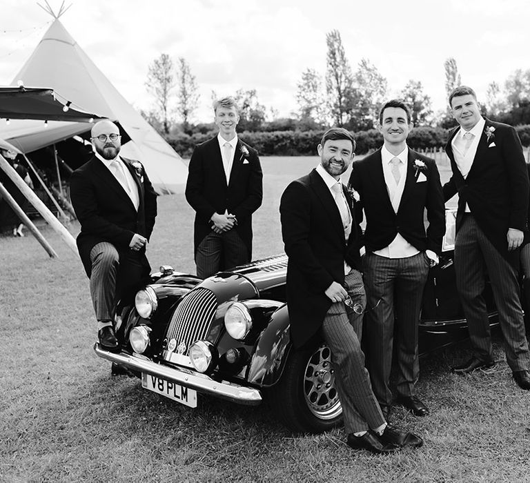 groomsmen-with-classic-wedding-car