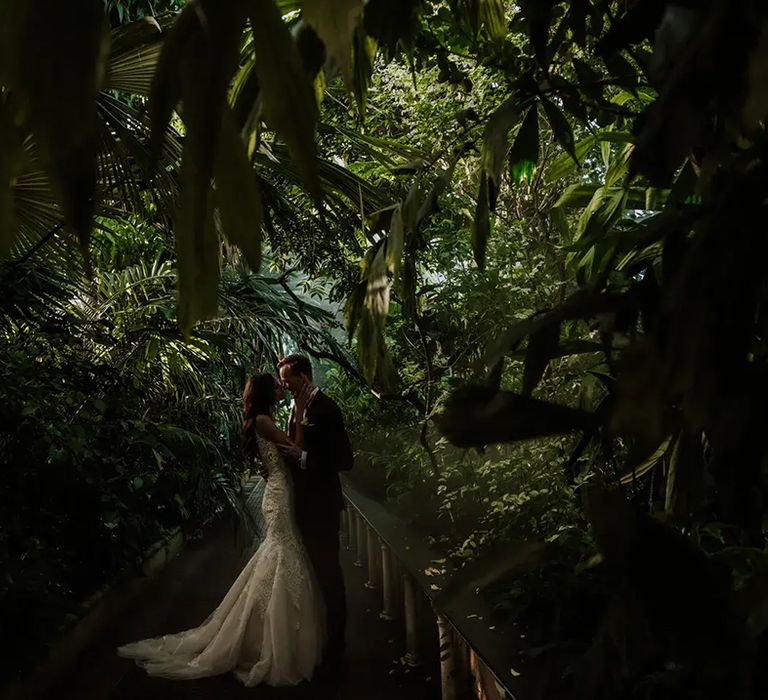 royal botanic gardens, kew, luxury wedding venue with couple amongst plants inside greenhouse