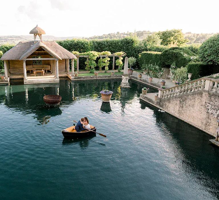 euridge manor luxury wedding venue with couple rowing in water feature