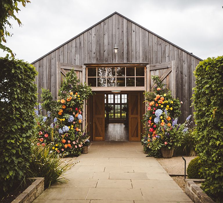 colourful-flower-columns-decorating-entrance-to-wedding