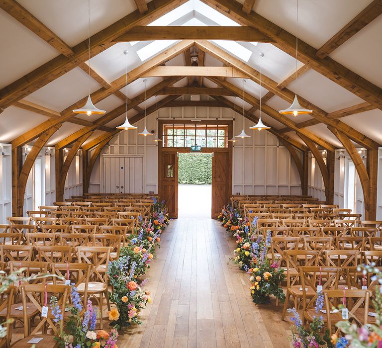 hyde-house-barn-wedding-with-pastel-aisle-flower-arrangements