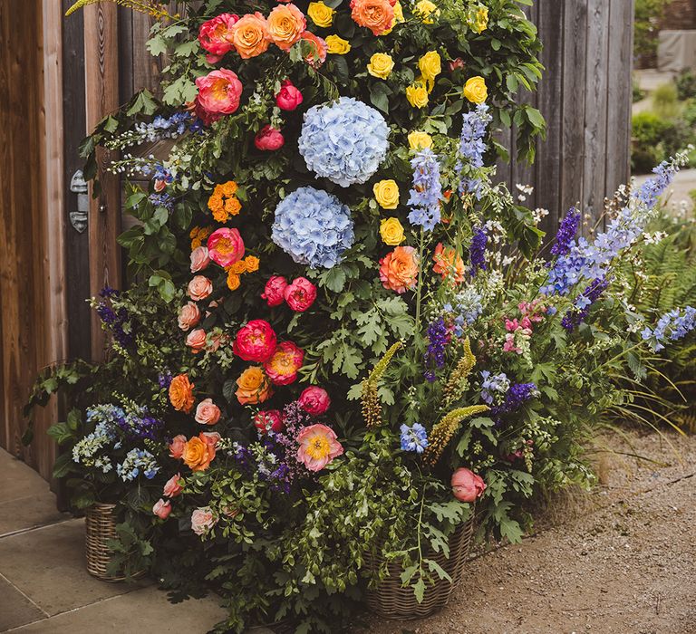 red-orange-yellow-and-blue-rainbow-wedding-flower-column