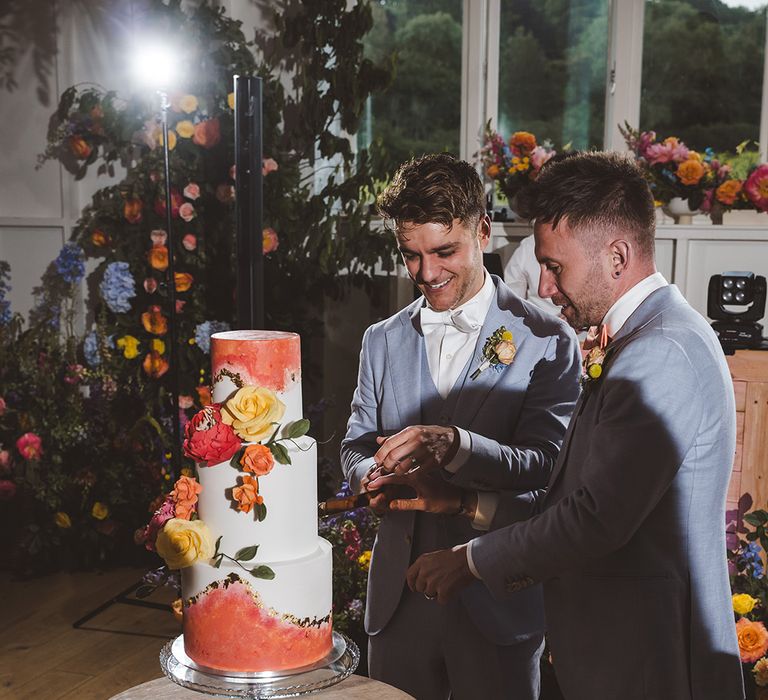 two-grooms-cut-wedding-cake