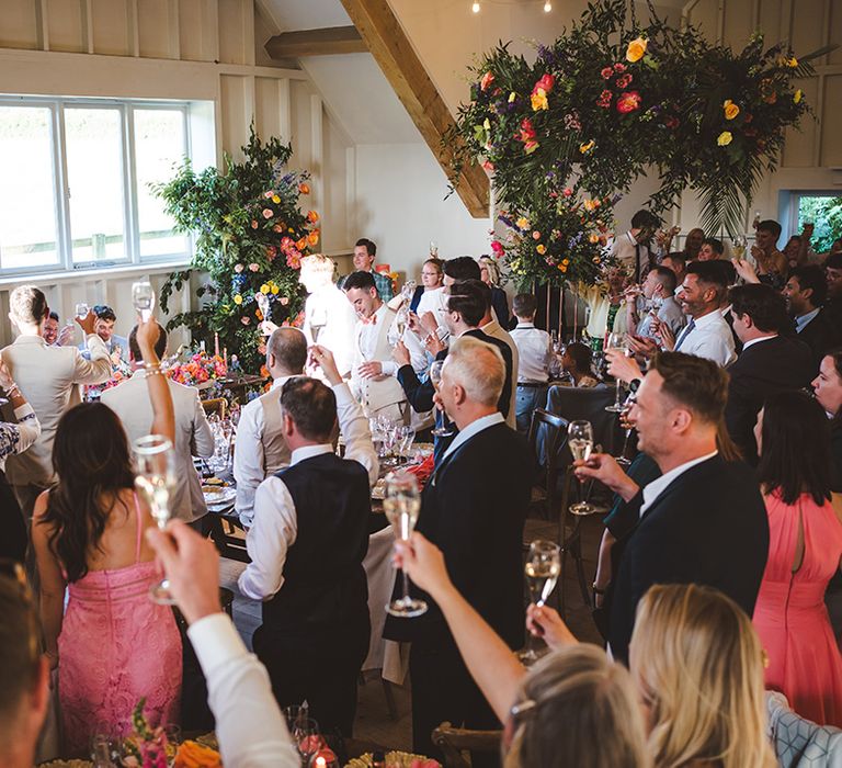 wedding-guests-making-toast-to-the-happy-couple