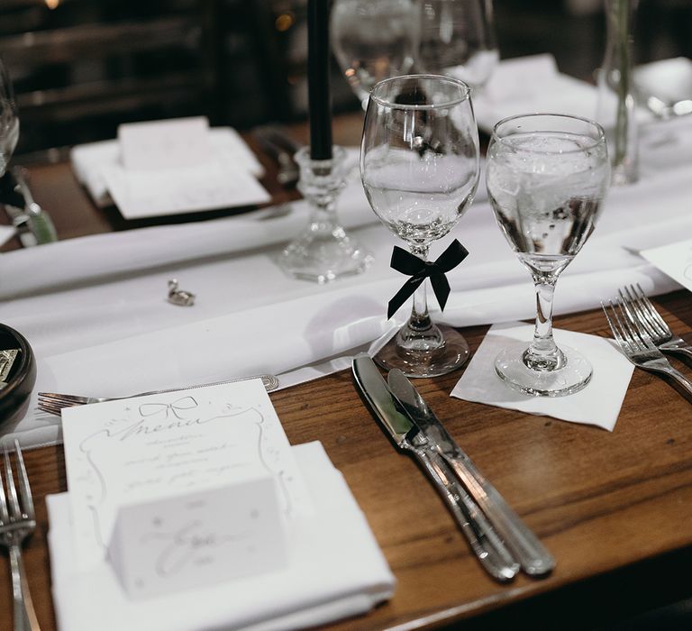 all-white-wedding-tablescape-with-black-bows