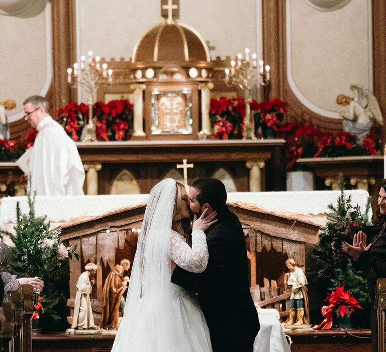 bride-and-groom-share-first-kiss-at-cathedral-wedding