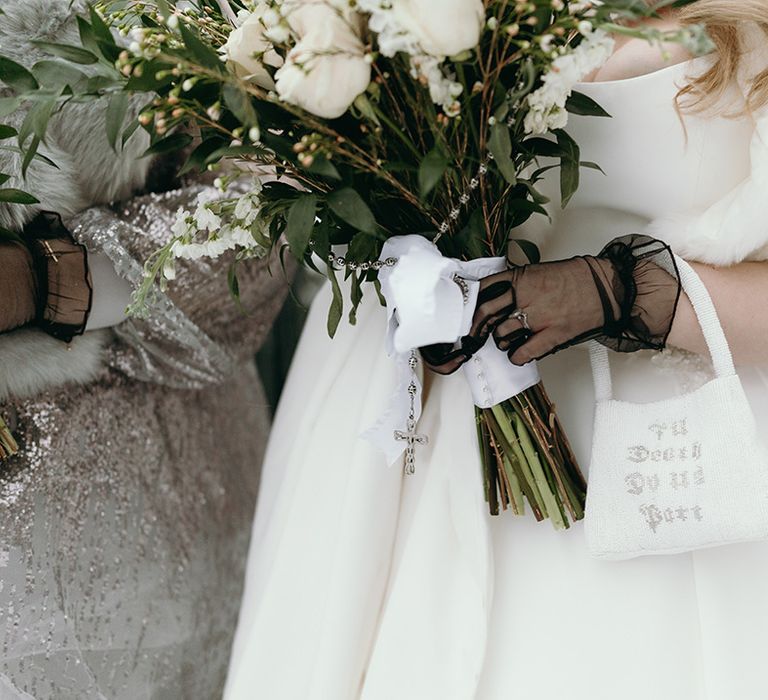 bride-holding-beaded-wedding-bag-with-white-rose-bouquet