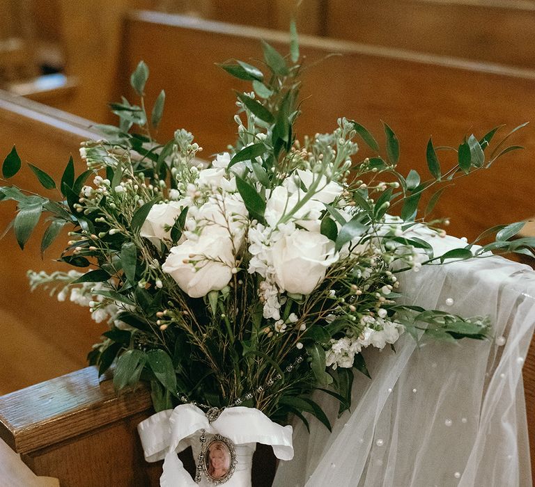 white-bridal-bouquet-with-white-ribbon-and-charm