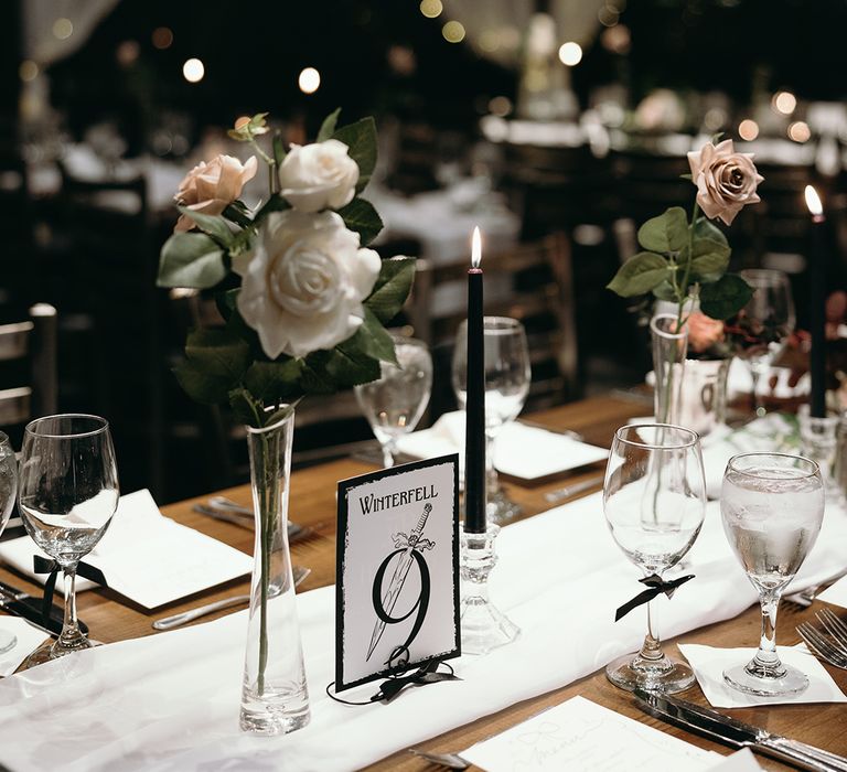 white-rose-table-decorations-with-black-and-white-wedding-table-number-sign