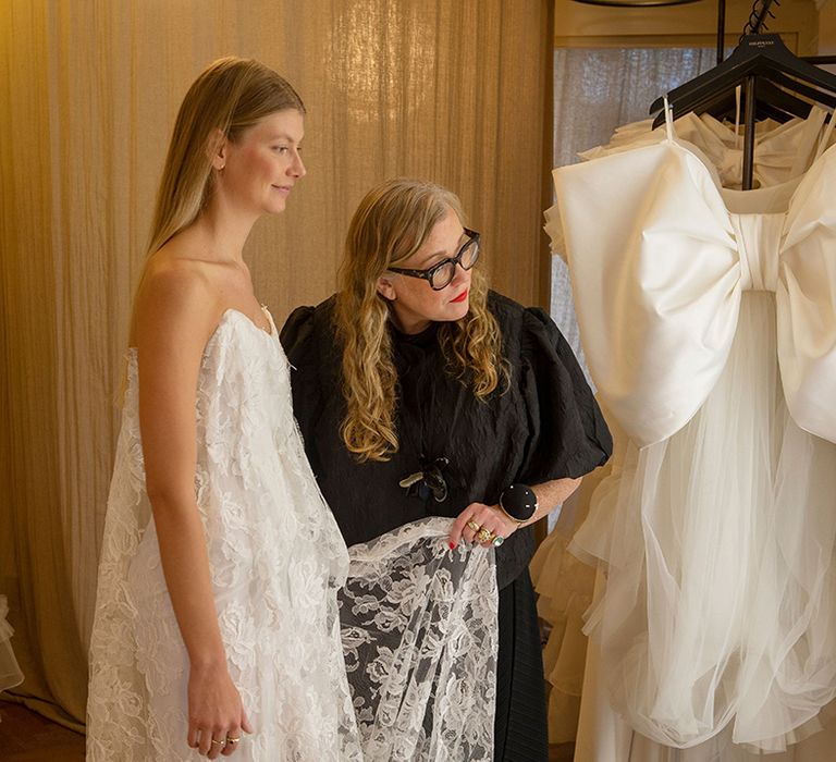 Halfpenny London designer and founder Kate Halfpenny working with bride on custom lace gown