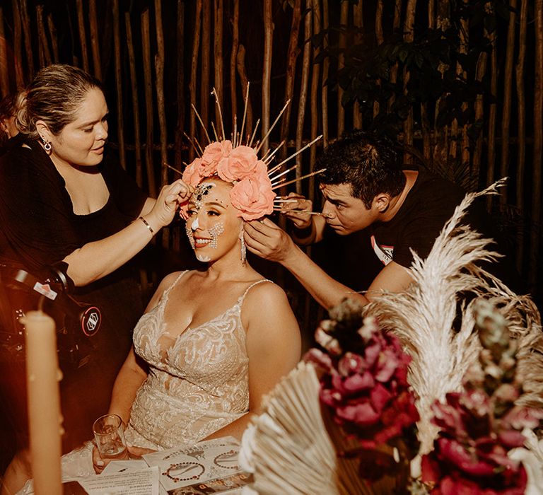 bride-gets-dressed-in-day-of-the-dead-wedding-makeup-and-cultural-headdress