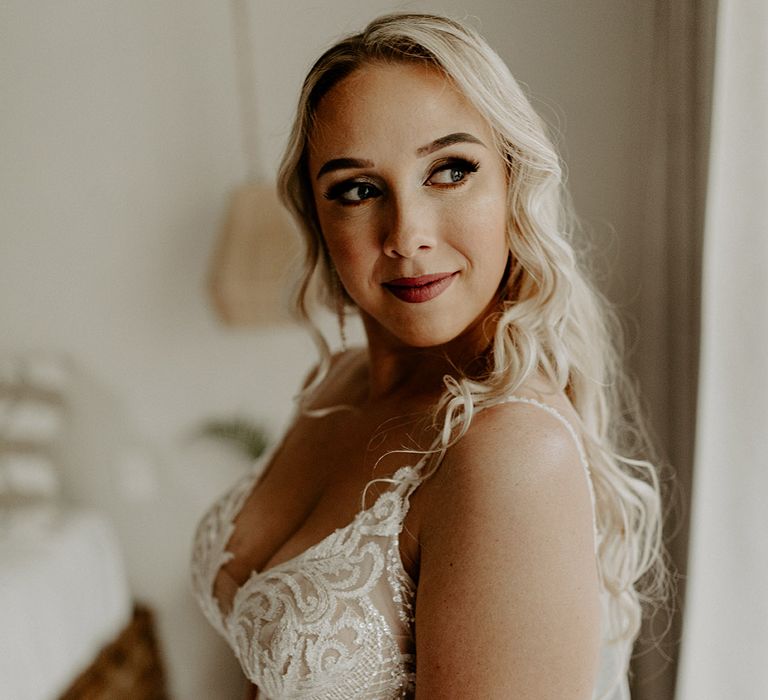 bride-wearing-lace-wedding-dress-with-curled-blonde-hair