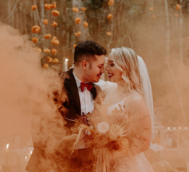 orange-smoke-flare-wedding-photo-with-boho-decor.