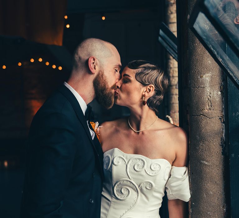 bride-wearing-vintage-wedding-dress-kissing-groom