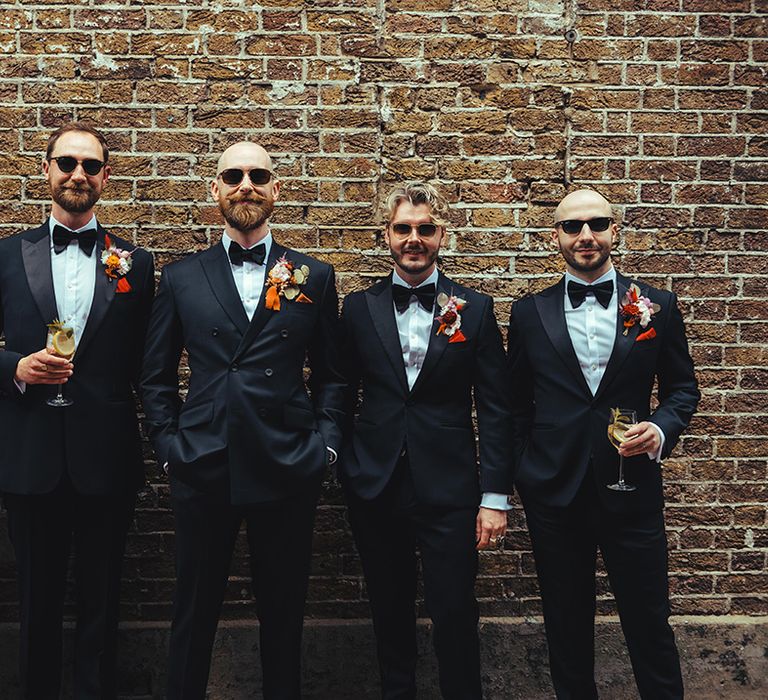 groom-and-groomsmen-wearing-black-tuxedo-and-sunglasses