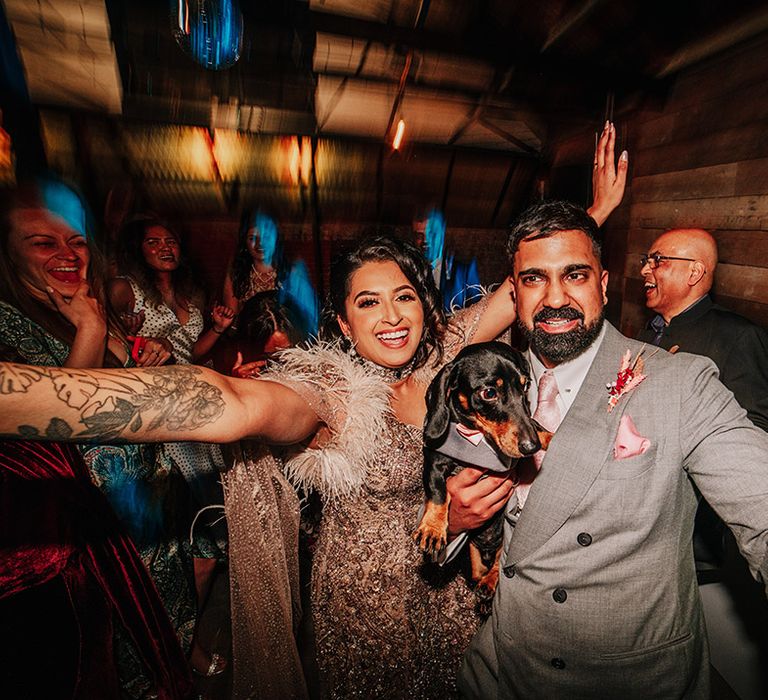 bride-and-groom-with-pet-dog-at-wedding