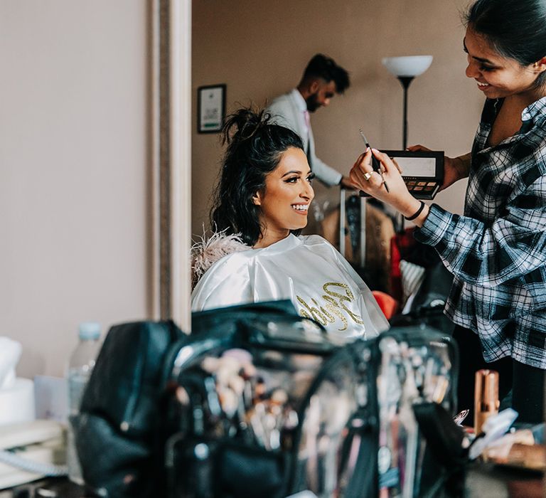 bride-gets-wedding-makeup-done-for-wedding-day