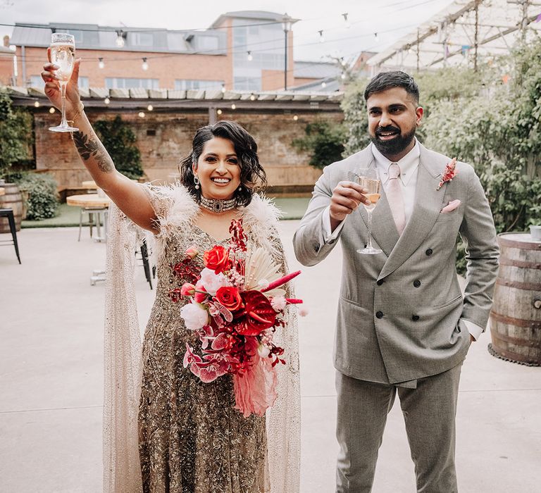 groom-in-light-grey-double-breasted-wedding-suit-with-bride-in-beaded-wedding-dress