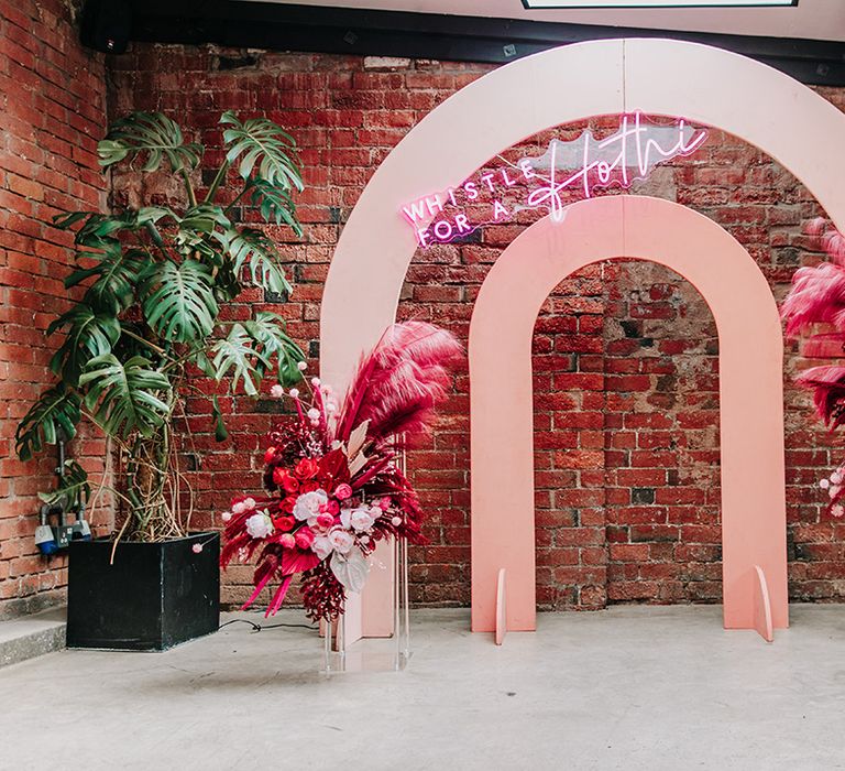 pink-arched-wedding-altar-decor-with-neon-sign-and-dried-flowers