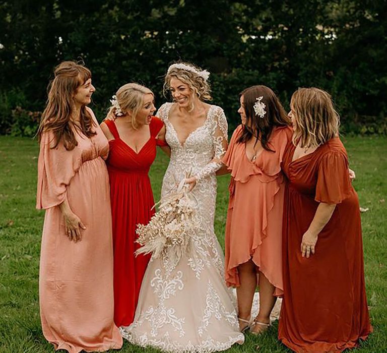 mismatched peach, orange and red bridesmaid dresses