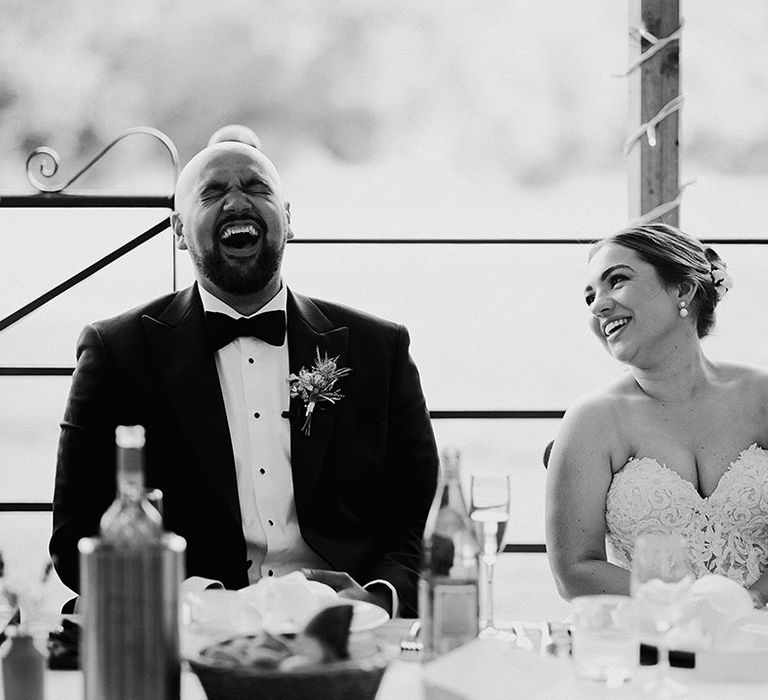 bride-and-groom-laughing-during-wedding-speeches