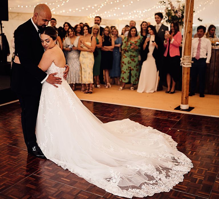 bride-in-lace-edge-wedding-dress-with-groom-in-black-tuxedo