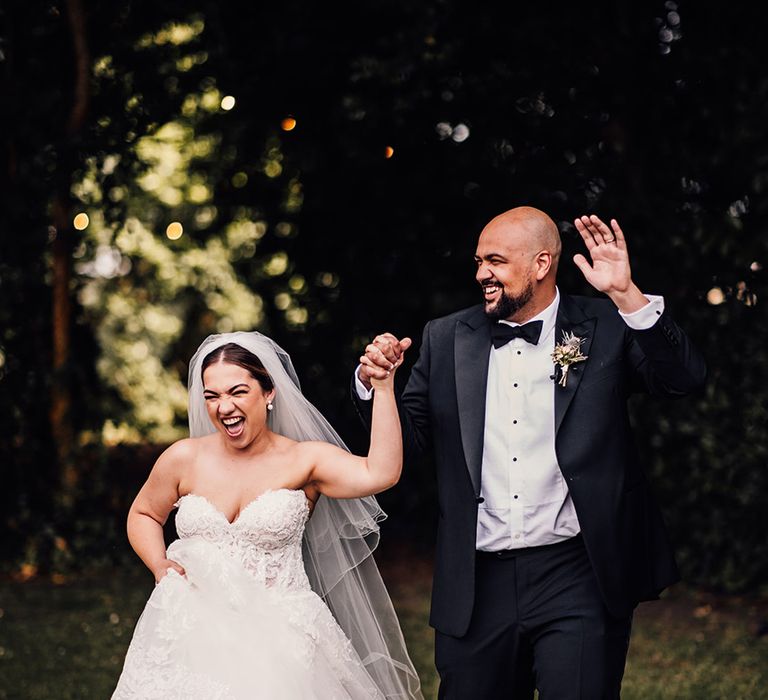 bride-in-strapless-wedding-gown-with-lace-with-groom-in-black-tuxedo