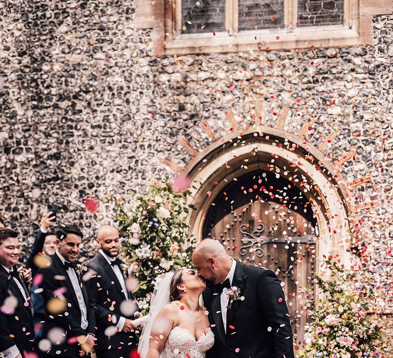 colourful-confetti-moment-as-bride-and-groom-at-church-wedding