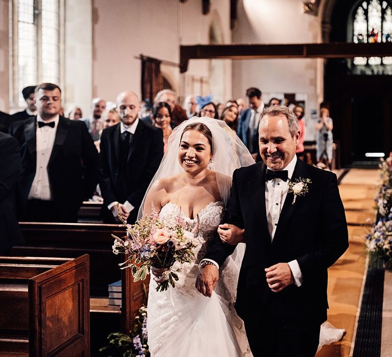 father-of-the-bride-in-black-tuxedo-walking-down-the-aisle-at-church-wedding