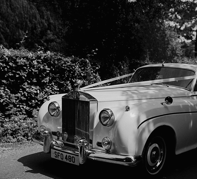 vintage-luxe-wedding-car-with-white-ribbon