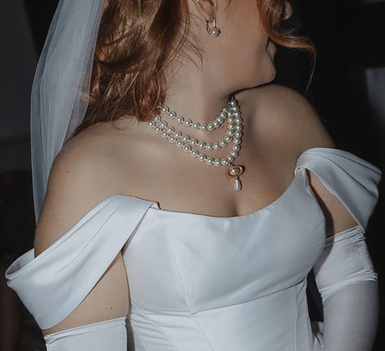 layered pearl wedding necklace, paired with corset-style off-shoulder wedding dress