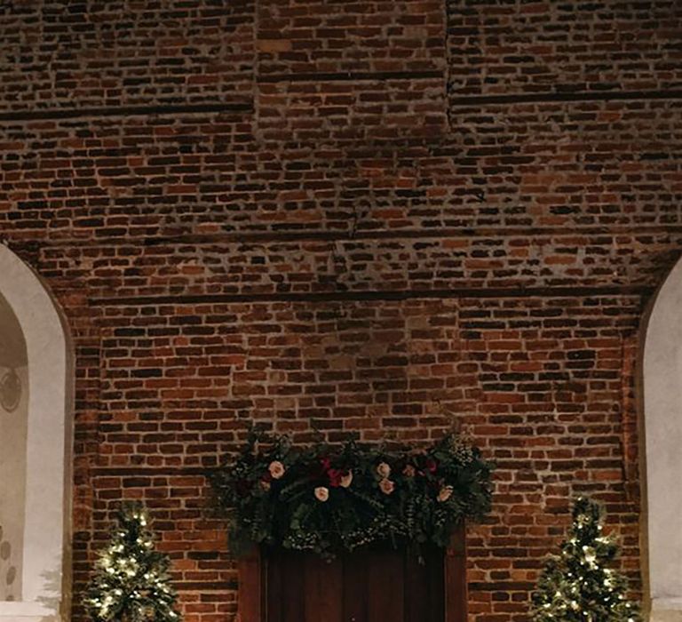 winter wedding venue with two christmas trees and festive decor