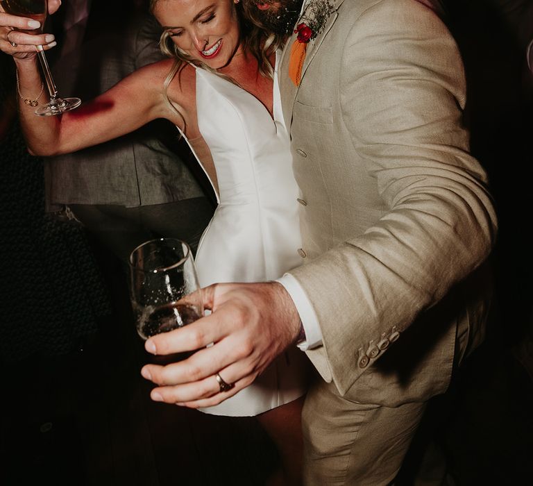 bride-in-short-wedding-reception-dress-dancing-with-groom