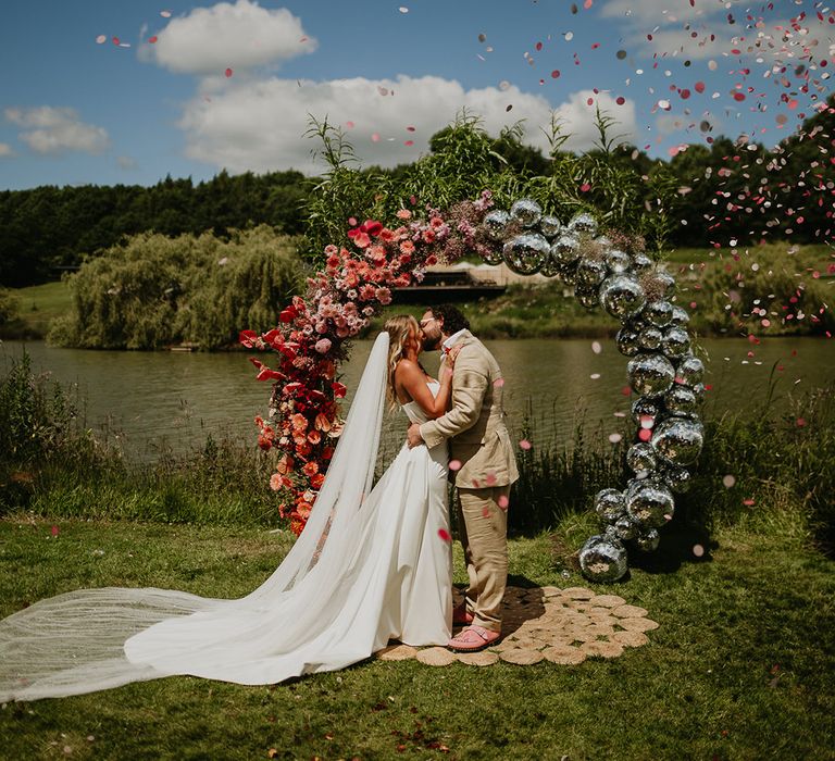 confetti-for-bride-and-groom-with-half-flower-half-disco-ball-arch