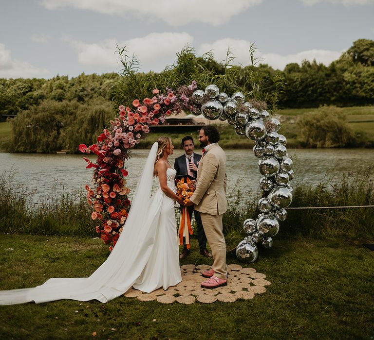 flower-and-disco-ball-wedding-arch-for-outdoor-wedding-ceremony