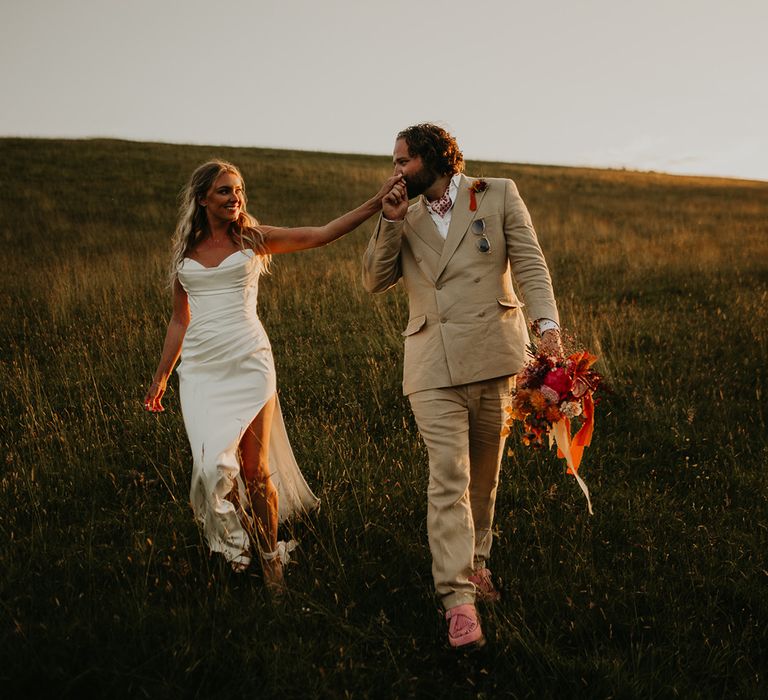 groom-kisses-brides-hand-at-wedding