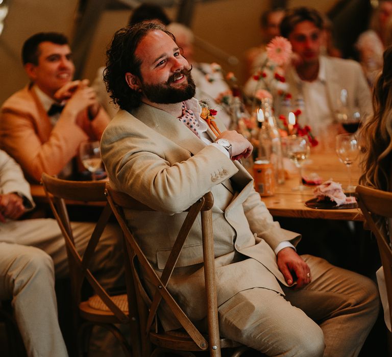 groom-wearing-pink-grooms-shoes-listening-to-wedding-speeches