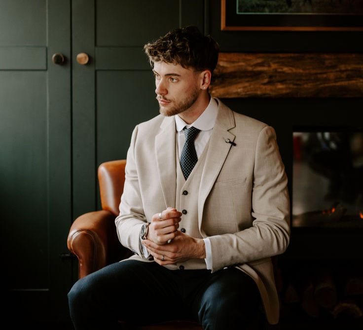 groom-with-beige-suit-with-curled-wedding-hair