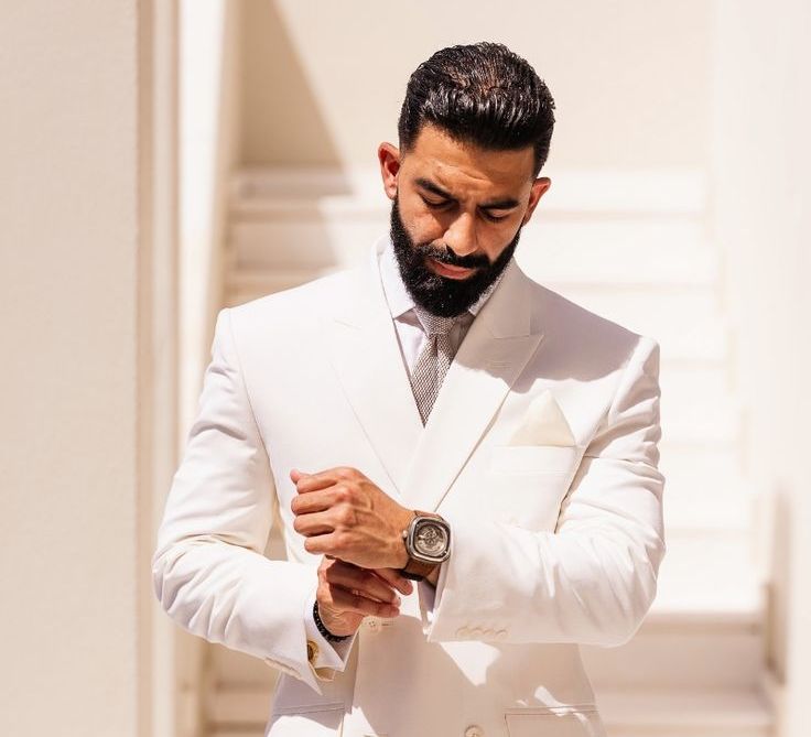 groom-in-white-suit-lookingg-groomed-for-wedding