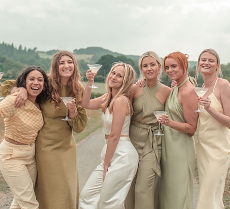 bridesmaids wearing laid-back green satin cocktail style dresses for wedding