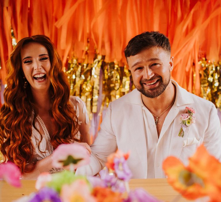 bride-and-groom-with-colourful-streamers-and-flowers