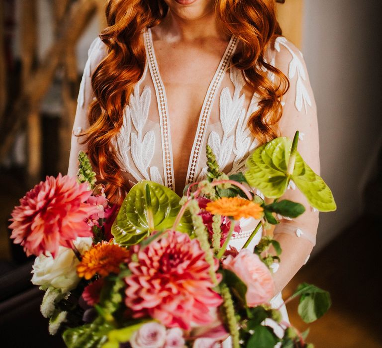 bride-with-curled-red-hair-with-pink-flower-wedding-bouquet