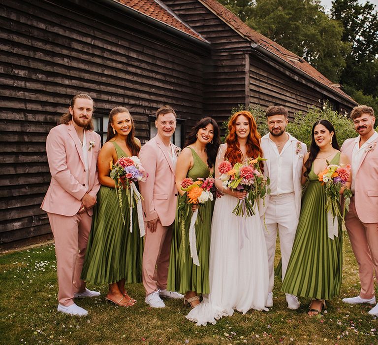 bridesmaid-in-green-bridesmaid-dresses-and-groomsmen-in-pink-suits