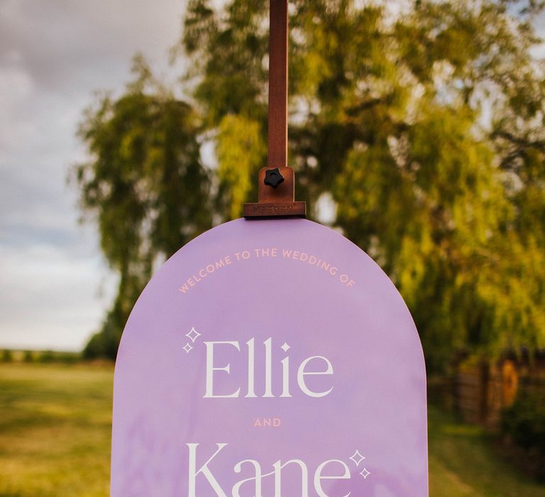 purple-arched-wedding-welcome-sign