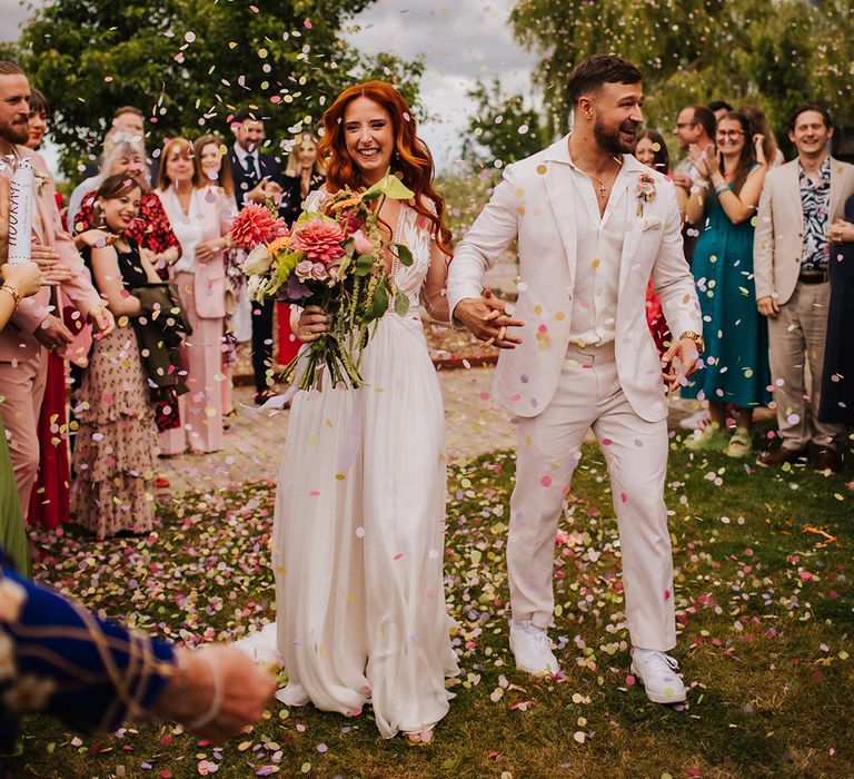 vibrant-confetti-moment-for-brode-and-groom-outdoors