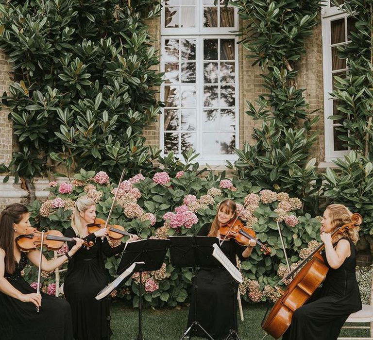 string-quartet-playing-at-country-house-wedding-venue