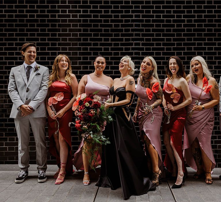 bridal-party-wearing-pink-bridesmaid-dresses-and-grey-bridesman-suits