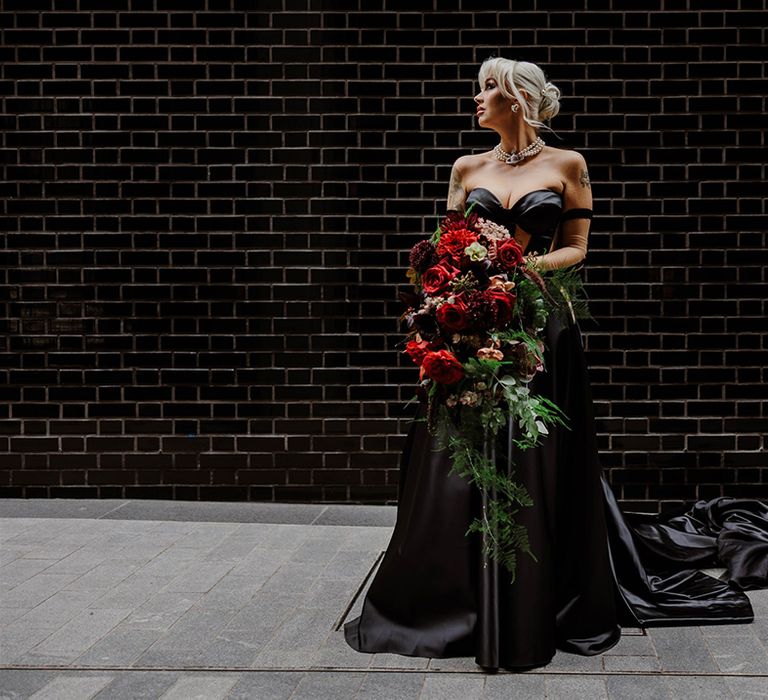 bride-holding-large-red-rose-oversized-wedding-bouquet