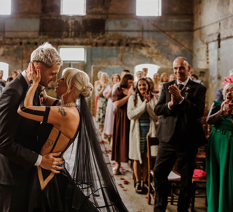 first-kiss-for-bride-and-groom-at-wedding