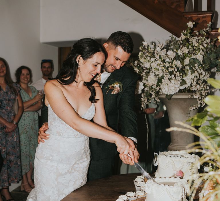 bride-and-groom-cutting-heart-shaped-wedding-cake